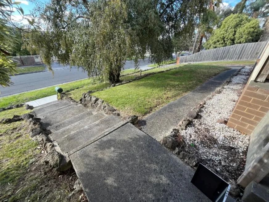 Before: concrete steps climbing in stages across a sloping front garden, with nothing to hold on to