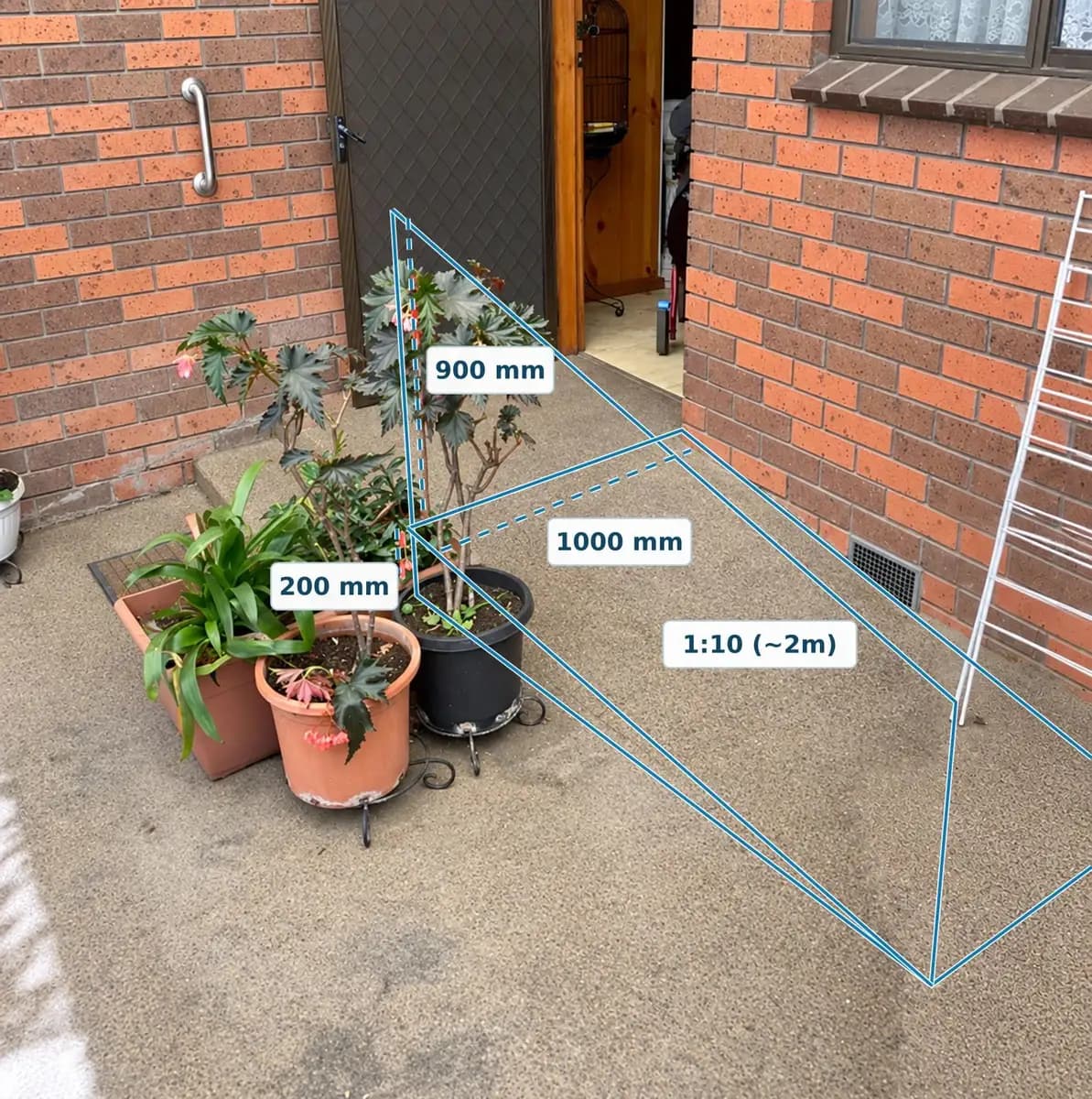 Before: a back entrance with a 200 mm step, marked up for a 1000 mm wide ramp at a 1:10 gradient, about 2 m long