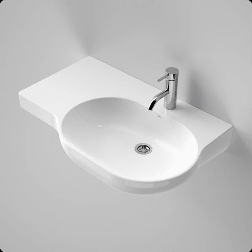 A white wheelchair-accessible wall-hung basin with a shelf on the left