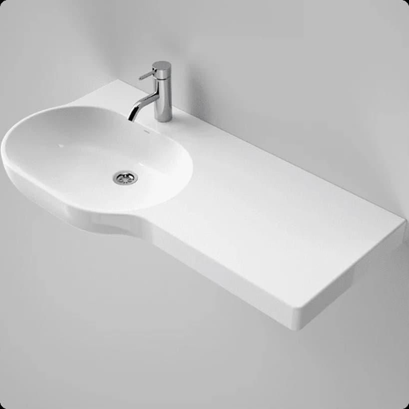 A wide white wheelchair-accessible basin with a shelf on the right