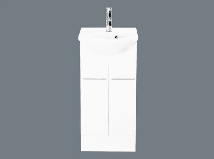 A narrow white semi-recessed vanity with a single door