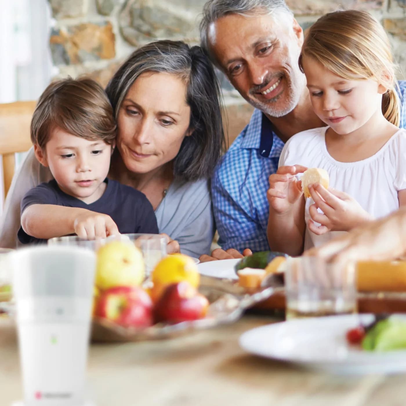 A family eating breakfast at a kitchen table, with a Bellman flash receiver in the foreground