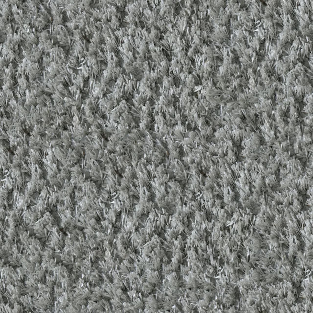 A grey loop-pile carpet, photographed close up to show the texture
