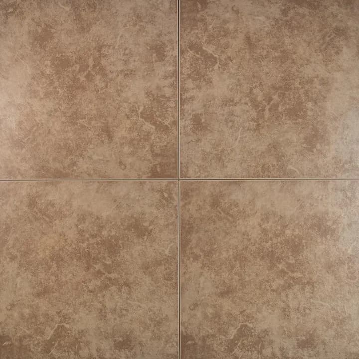 A matte brown floor tile with a mottled stone finish and visible grout lines