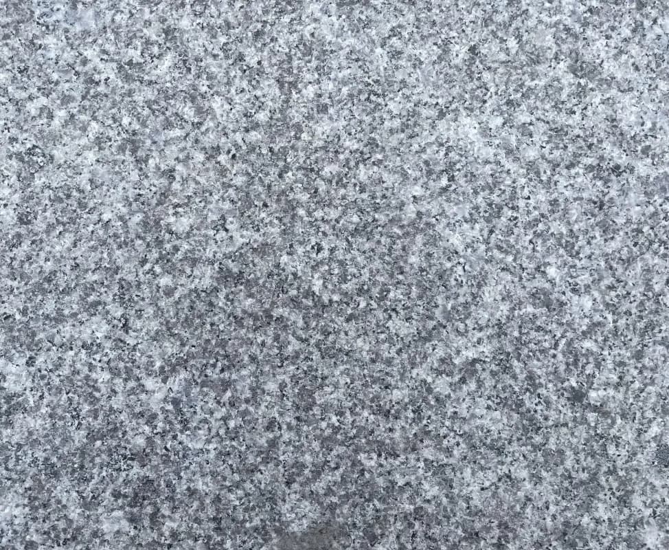 A granite-look vinyl plank in grey and white speckle
