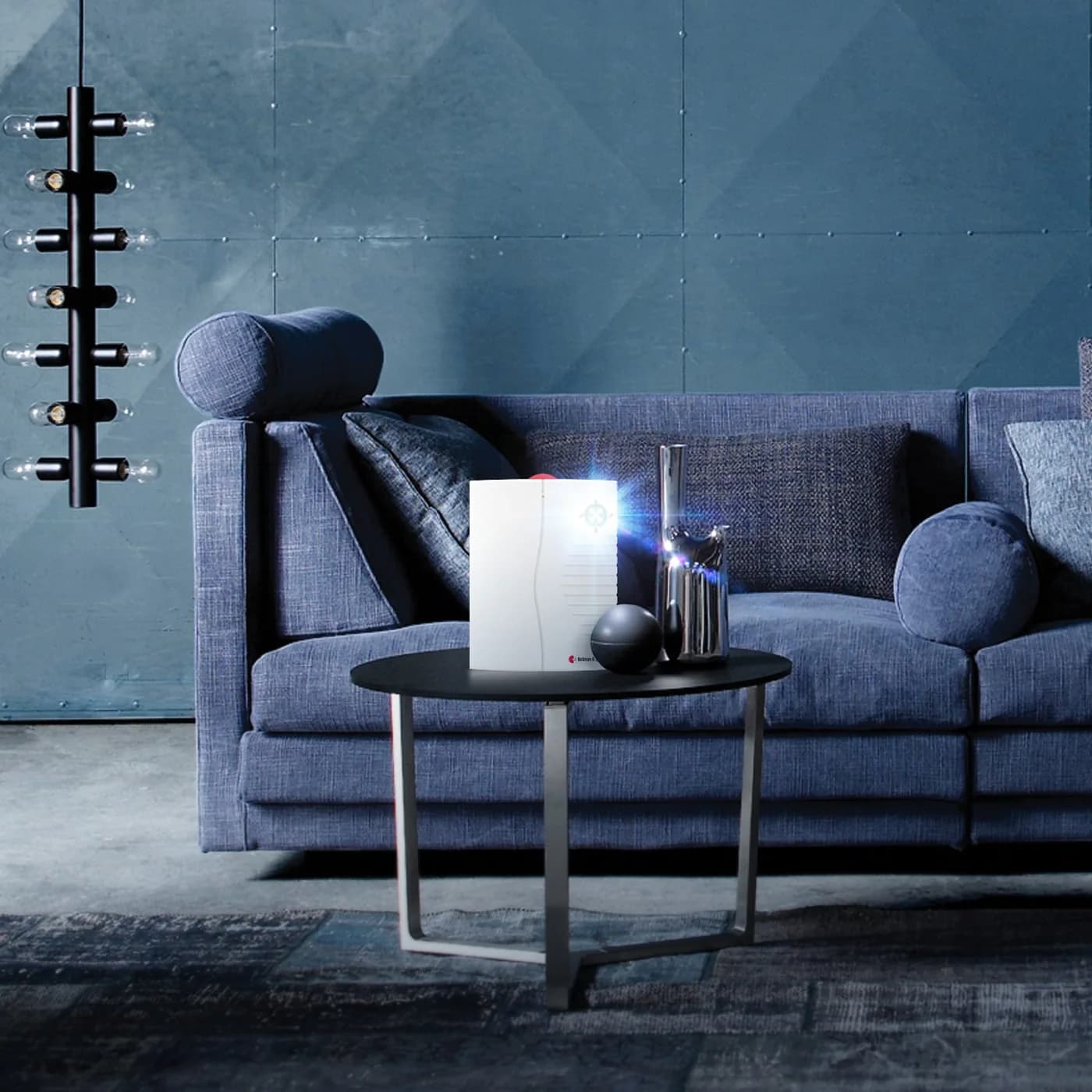 A Bellman portable receiver flashing on a coffee table in front of a blue sofa