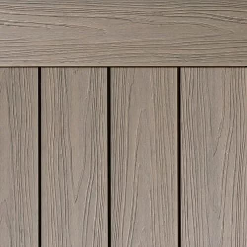 Composite decking boards in a pale grey driftwood tone with a fine woodgrain texture
