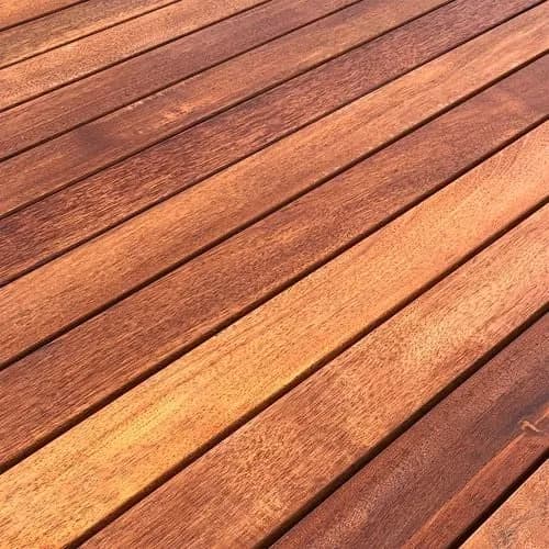 Merbau hardwood decking boards laid diagonally, showing the deep reddish-brown grain